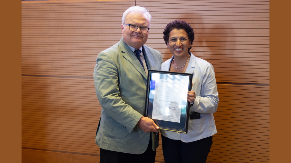 Geeta Swamy, MD, interim chair of the Department of Dermatology, poses with John Murray, MD, after Murray received his award.